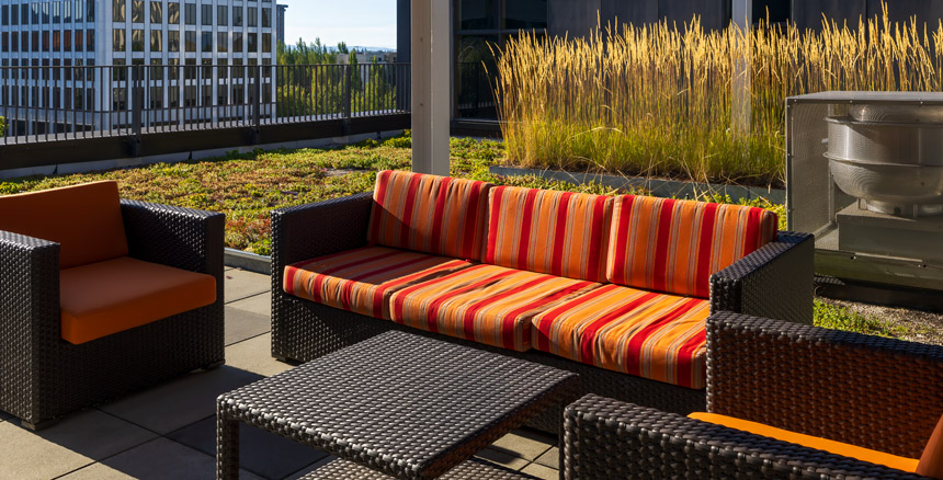 Furniture on green rooftop patio of Velomor at Hassalo on Eighth urban luxury apartments in Portland, Oregon's Lloyd District